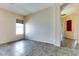 Spacious open-concept living area with lots of natural light from a large window at 11664 W Eagle Ct, Surprise, AZ 85378