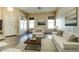 Cozy staged living room with neutral walls, tile floors, a ceiling fan, and a modern sofa at 11664 W Eagle Ct, Surprise, AZ 85378