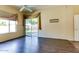 Bright room with wood floors, a ceiling fan, and a sliding glass door leading to a patio and backyard at 11664 W Eagle Ct, Surprise, AZ 85378