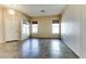 Unfurnished living area with tile flooring, neutral walls, large windows, and modern chandelier at 11664 W Eagle Ct, Surprise, AZ 85378