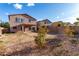 Expansive backyard featuring desert landscaping and a covered patio, perfect for outdoor entertaining and relaxation at 1222 E Canyon Trl, San Tan Valley, AZ 85143