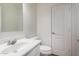 Neat half bath features a white vanity and white toilet at 1222 E Canyon Trl, San Tan Valley, AZ 85143