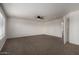 Open bedroom with a ceiling fan, neutral carpet, and large window allowing for ample light at 1222 E Canyon Trl, San Tan Valley, AZ 85143
