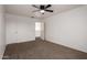 Bedroom featuring carpet, ceiling fan, and doorways to adjacent rooms at 1222 E Canyon Trl, San Tan Valley, AZ 85143