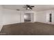 Large bedroom features a ceiling fan, neutral carpet, and an ensuite bath at 1222 E Canyon Trl, San Tan Valley, AZ 85143