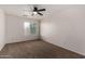 Well-lit bedroom featuring carpet, a ceiling fan, and a window view at 1222 E Canyon Trl, San Tan Valley, AZ 85143
