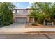 Inviting two-story home showcasing desert landscaping, a two-car garage, and covered front porch at 1222 E Canyon Trl, San Tan Valley, AZ 85143