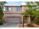 Inviting two-story home showcasing desert landscaping, a two-car garage, and covered front porch at 1222 E Canyon Trl, San Tan Valley, AZ 85143