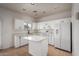 Bright kitchen with white cabinets, an island, stainless appliances, and tile flooring at 1222 E Canyon Trl, San Tan Valley, AZ 85143