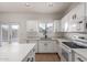 Bright kitchen features white cabinets, modern appliances, and a window overlooking the backyard at 1222 E Canyon Trl, San Tan Valley, AZ 85143