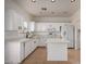 Bright kitchen with white cabinets, an island, stainless appliances, and tile flooring at 1222 E Canyon Trl, San Tan Valley, AZ 85143