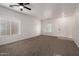 This living room features neutral carpet, ceiling fan, window, and freshly painted white walls at 1222 E Canyon Trl, San Tan Valley, AZ 85143