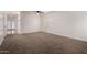 This living room features neutral carpet, ceiling fan, window, freshly painted white walls, and open entry at 1222 E Canyon Trl, San Tan Valley, AZ 85143