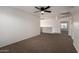 Spacious loft area with neutral carpet, ceiling fan, and access to other rooms at 1222 E Canyon Trl, San Tan Valley, AZ 85143