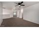 A carpeted loft with white walls, a ceiling fan, and an open doorway to another room at 1222 E Canyon Trl, San Tan Valley, AZ 85143