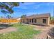 Spacious backyard has a well-maintained lawn and ample room for outdoor activities, shaded by mature trees at 1308 E Rosemonte Dr, Phoenix, AZ 85024