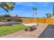 Expansive backyard with a stone table, lush grass, garden beds, and palm trees at 1308 E Rosemonte Dr, Phoenix, AZ 85024