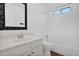 Neat bathroom with a white vanity, framed mirror, and tiled shower-tub combo at 1308 E Rosemonte Dr, Phoenix, AZ 85024