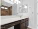 Bathroom featuring dual mirrors, ample counter space, vanity lighting, and a walk-in shower at 1308 E Rosemonte Dr, Phoenix, AZ 85024