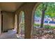 Charming stucco porch featuring textured support columns, climbing vines, and a view of the front yard at 1308 E Rosemonte Dr, Phoenix, AZ 85024