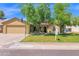 Charming single-Gathering home with a spacious front yard, mature trees, and an attached two-car garage at 1308 E Rosemonte Dr, Phoenix, AZ 85024