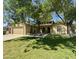 Charming home featuring a well-manicured lawn, mature trees, and a welcoming, arched front entrance at 1308 E Rosemonte Dr, Phoenix, AZ 85024