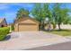 Charming home featuring a well-manicured lawn, mature trees, basketball hoop, and an attached two-car garage at 1308 E Rosemonte Dr, Phoenix, AZ 85024