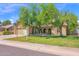Inviting front of a home featuring mature trees, manicured lawn, basketball hoop and attached two-car garage at 1308 E Rosemonte Dr, Phoenix, AZ 85024