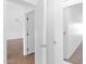 Bright hallway featuring an open door and mirrored closet doors at 1308 E Rosemonte Dr, Phoenix, AZ 85024