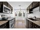 Charming kitchen featuring granite countertops and stainless steel appliances, highlighted by a window with a view at 1308 E Rosemonte Dr, Phoenix, AZ 85024