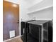 Well-lit laundry room featuring a modern washer and dryer set, and convenient storage shelves at 1308 E Rosemonte Dr, Phoenix, AZ 85024