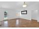 Bright living room featuring tile flooring, modern lighting, a ceiling fan, and large windows for natural light at 1308 E Rosemonte Dr, Phoenix, AZ 85024