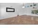 A spacious living room featuring tile flooring, high ceilings, and a decorative mirror above the wall at 1308 E Rosemonte Dr, Phoenix, AZ 85024