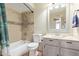 Updated bathroom with tiled shower and a single sink vanity at 1348 W Rockwood Dr, Phoenix, AZ 85027