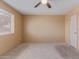 Comfortable bedroom with neutral carpet, a ceiling fan, and a bright window at 1348 W Rockwood Dr, Phoenix, AZ 85027