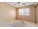 Bedroom with neutral carpet, window, tan walls and closet with sliding mirrored doors at 1348 W Rockwood Dr, Phoenix, AZ 85027
