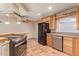 Open concept kitchen features stainless appliances, custom cabinetry, and convenient breakfast bar at 1348 W Rockwood Dr, Phoenix, AZ 85027
