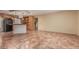 Open-concept kitchen with wooden cabinetry, breakfast bar, and tile flooring extends into dining area at 1348 W Rockwood Dr, Phoenix, AZ 85027