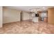 Open-concept kitchen with wooden cabinetry, breakfast bar, and tile flooring extends into dining area at 1348 W Rockwood Dr, Phoenix, AZ 85027