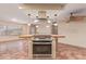Kitchen island with stovetop features stylish vent hood and seating, blending function with style at 1348 W Rockwood Dr, Phoenix, AZ 85027