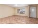 Bright living room featuring tile flooring, neutral walls, and a large window with privacy blinds at 1348 W Rockwood Dr, Phoenix, AZ 85027
