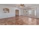 Spacious living room with tile flooring, archways, and sliding glass doors to the exterior at 1348 W Rockwood Dr, Phoenix, AZ 85027