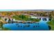 Panoramic aerial shot of a community featuring a lake, golf course, and palm trees at 14878 W Verde Ln, Goodyear, AZ 85395