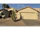 Charming home featuring a two-car garage, desert landscaping and mature cacti for added curb appeal at 14878 W Verde Ln, Goodyear, AZ 85395