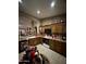 The kitchen features oak cabinetry, tile flooring, and a white oven at 14878 W Verde Ln, Goodyear, AZ 85395