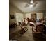 Cozy living area with hardwood floors, seating and natural light from the window shutters at 14878 W Verde Ln, Goodyear, AZ 85395