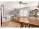 Bonus room with beige sofa, desk, ceiling fan and laminate wood flooring at 16036 N 11Th Ave # 1086, Phoenix, AZ 85023