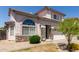 Inviting two-story home with stone accents, arched window, and a well-maintained lawn and landscaping at 16036 N 11Th Ave # 1086, Phoenix, AZ 85023