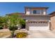 Two-story home featuring a stone facade and a two-car garage, complemented by a well-manicured front yard at 16036 N 11Th Ave # 1086, Phoenix, AZ 85023