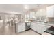 Bright kitchen featuring tile flooring, white cabinets, stainless steel appliances and adjacent dining area at 16036 N 11Th Ave # 1086, Phoenix, AZ 85023